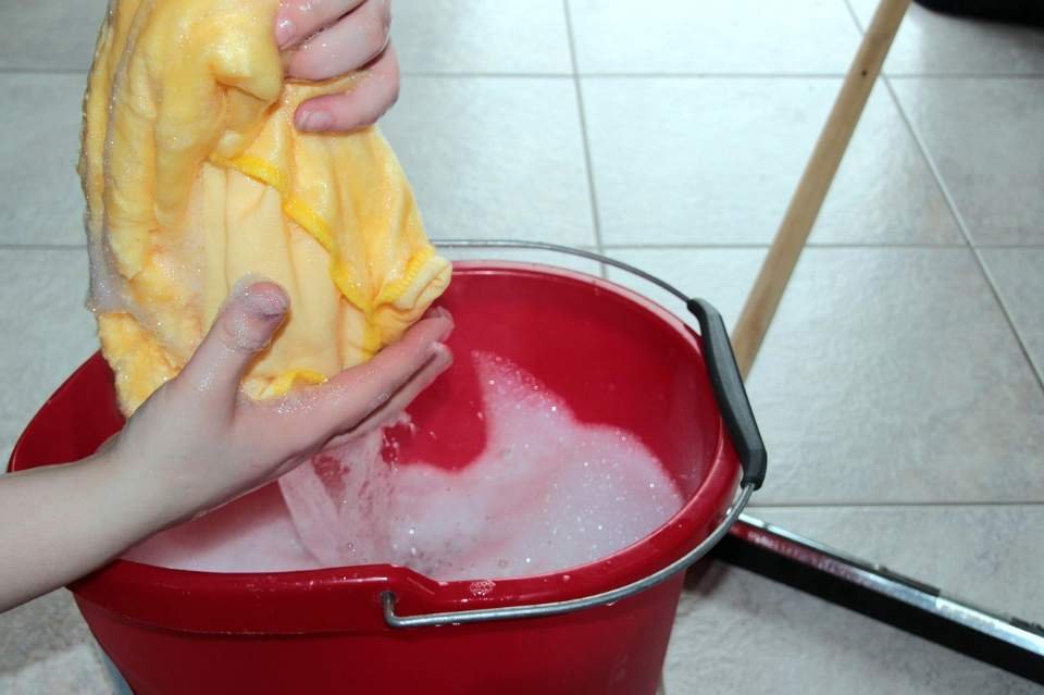 A person getting ready to clean and get mold out of hammock.