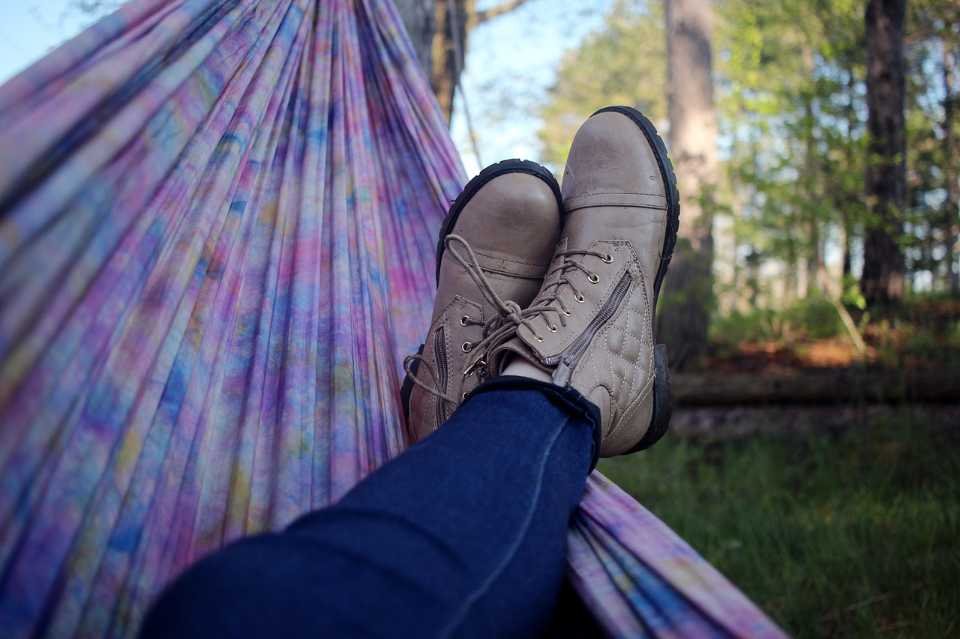 A person relaxing in a hammock.