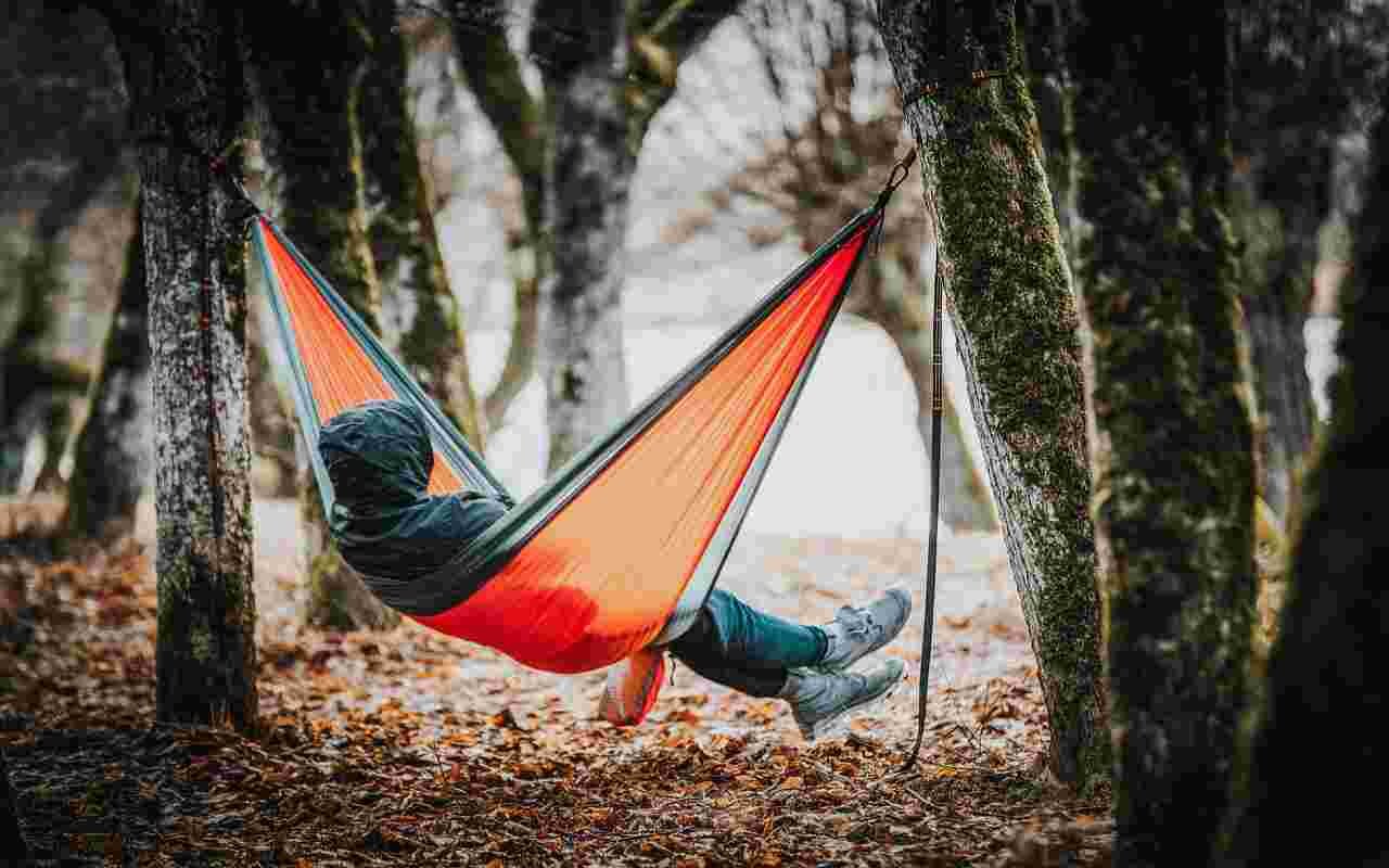 A person sitting in a hammock during extreme weather conditions.